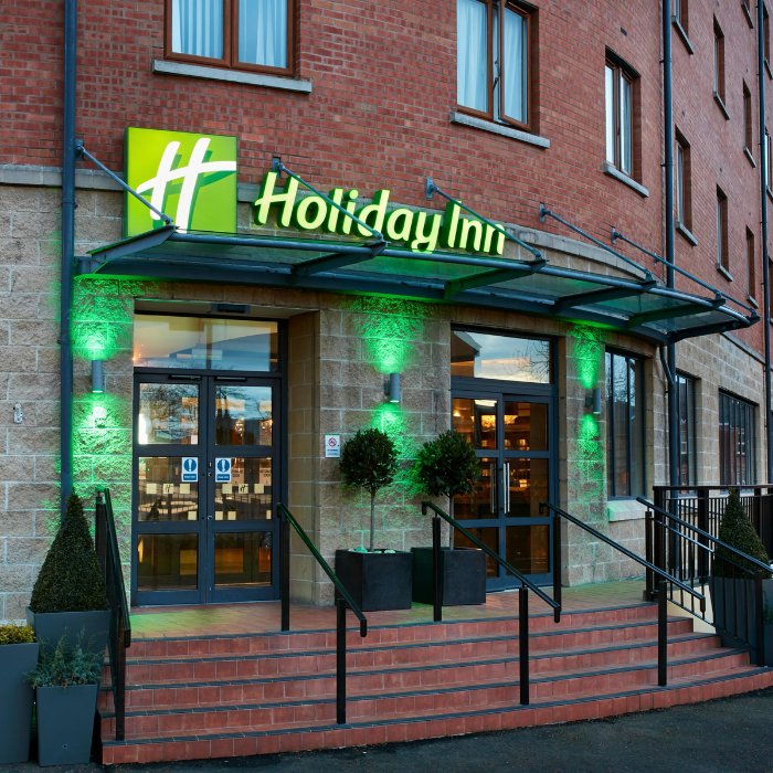 The illuminated entrance to Holiday Inn Belfast City Centre