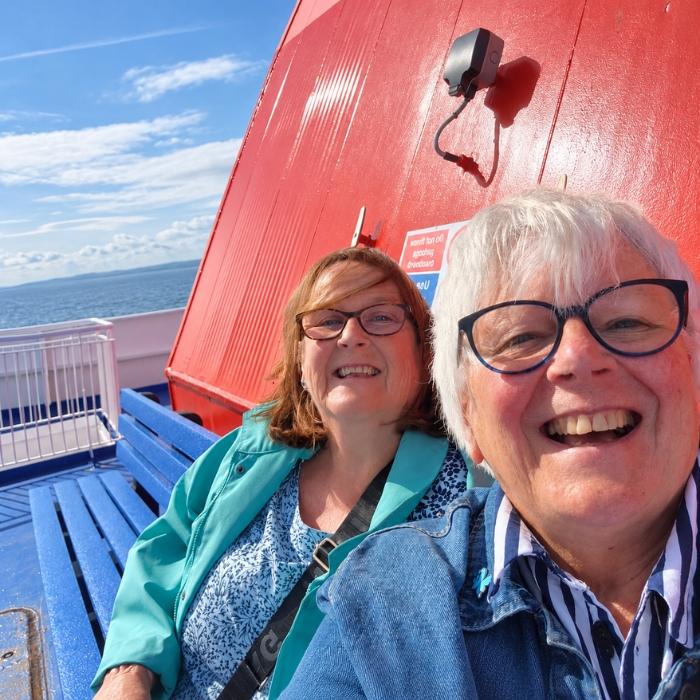 Travellers enjoying time together on an open ferry deck