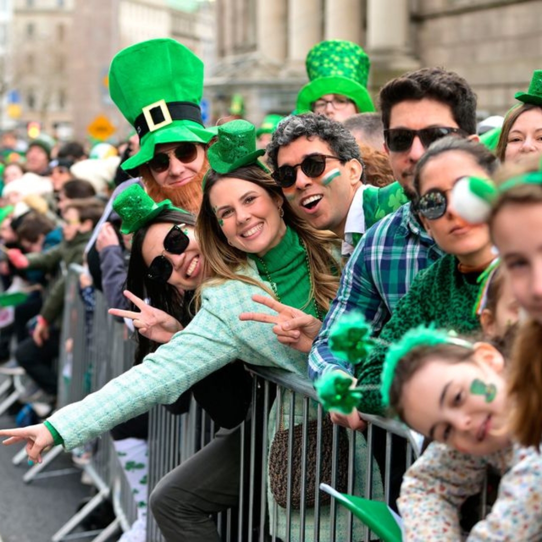 Smiling spectators dressed in green enjoying Belfast’s St Patrick’s celebrations