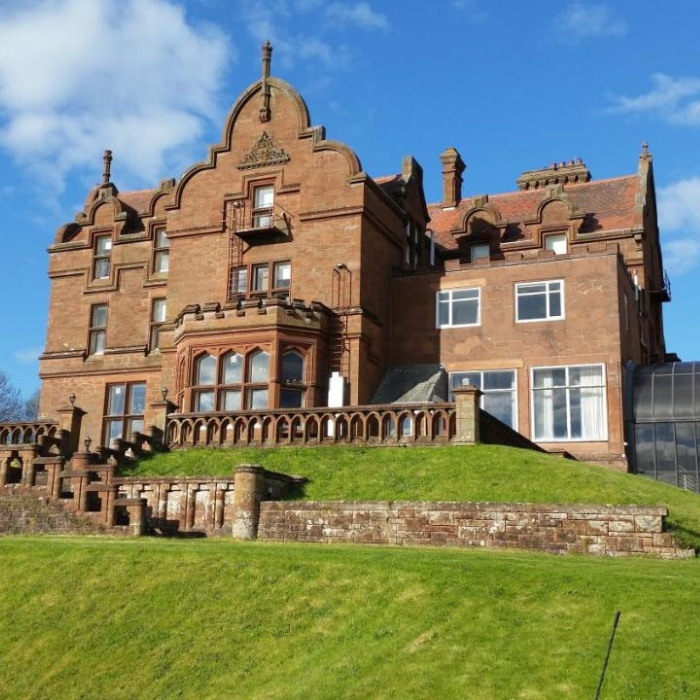 Red sandstone exterior and lawns of the Adamton Country House Hotel