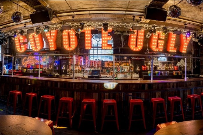 The illuminated Coyote Ugly sign above the saloon bar