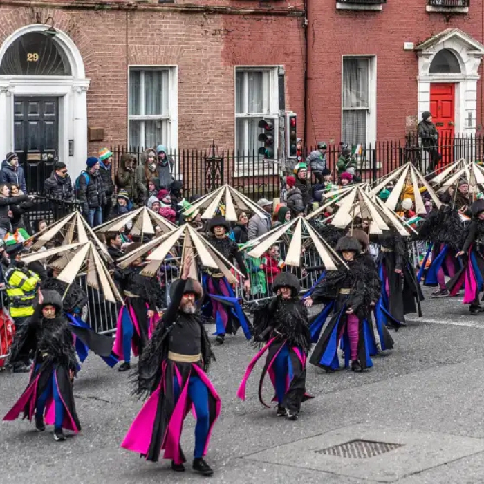 Costumed performers with sculptural headdresses in Dublin’s St Patrick’s parade