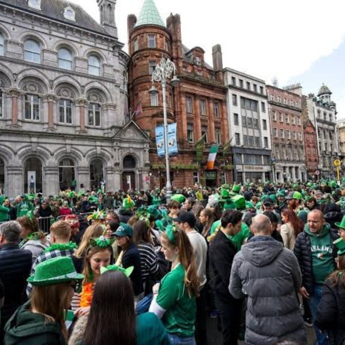 Spectators dressed in green gathering on Dublin’s streets for St Patrick’s Day