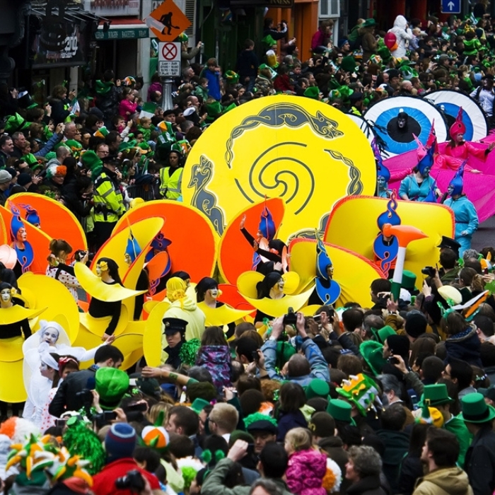 Bright yellow and orange pageant creations passing crowds at Dublin’s St Patrick’s Day parade