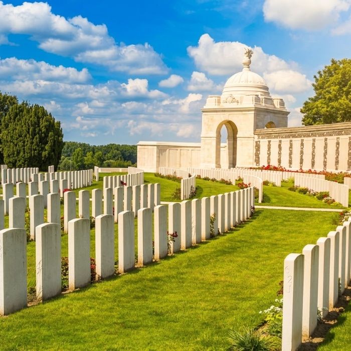 Rows of white headstones and the memorial at Tyne Cot Cemetery
