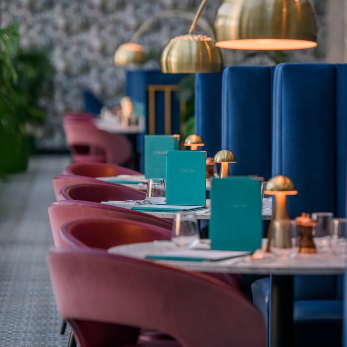 Velvet seating and brass lighting in the Clybaun Hotel&rsquo;s Courtyard restaurant