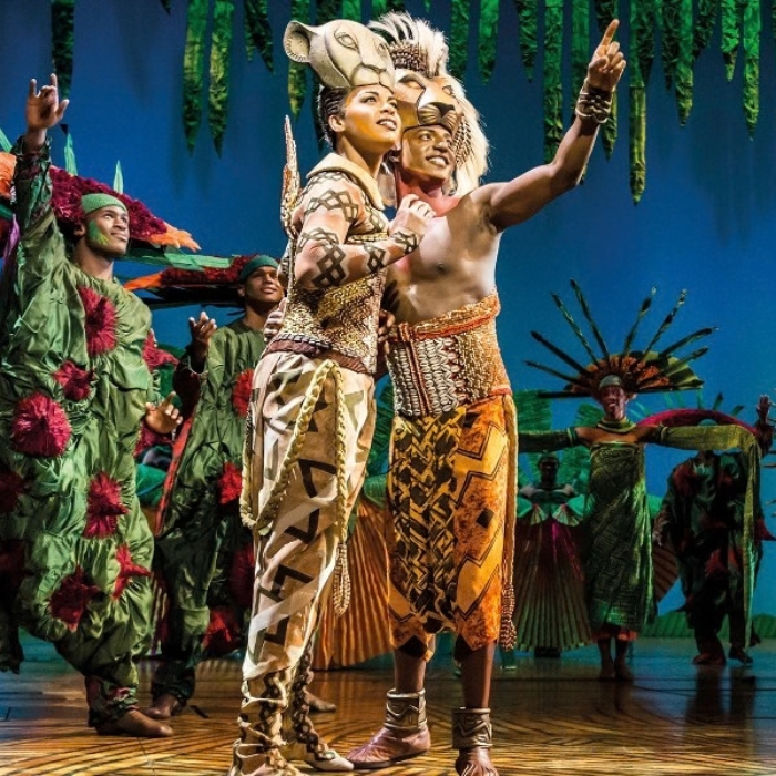 Cast members and theatrical animal puppetry in The Lion King