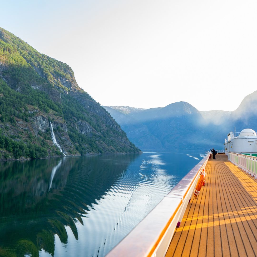 Fjord scenery viewed from the open deck of a cruise ship