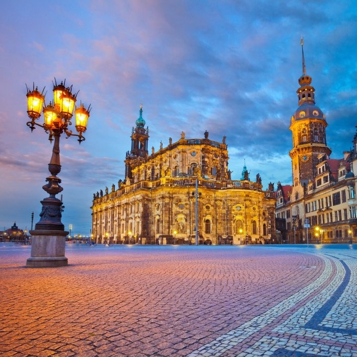 Dresden's historic buildings illuminated beside an open square