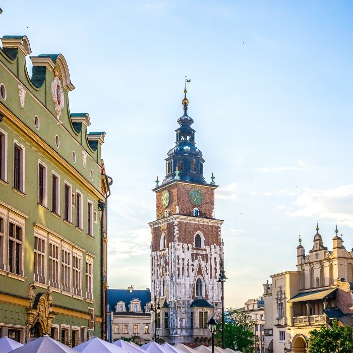 A characterful Krak&oacute;w street leading towards a historic tower