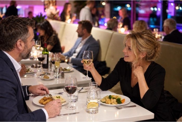 Guests enjoying dinner aboard a Prague river cruise