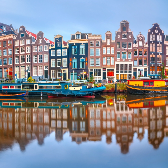 Gabled merchant houses reflected in an Amsterdam canal